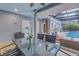 Covered patio with an outdoor dining table and seating area overlooking the pool in this backyard at 436 12Th Ne Ave, St Petersburg, FL 33701