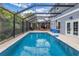 Screened in pool with a basketball hoop, patio and tropical landscaping in this backyard at 436 12Th Ne Ave, St Petersburg, FL 33701