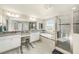 Bathroom with double sinks, granite countertops, soaking tub, walk in shower with glass door, and tile floor at 4607 Ballantrae Boulevard, Land O Lakes, FL 34638