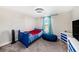 bedroom with single bed, carpet, side table, dresser, and one window providing natural light at 4607 Ballantrae Boulevard, Land O Lakes, FL 34638