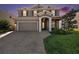 Charming two-story home with a well-manicured lawn and a paver driveway leading to a two-car garage at 4607 Ballantrae Boulevard, Land O Lakes, FL 34638