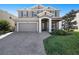Charming two-story home with a well-manicured lawn and a paver driveway leading to a two-car garage at 4607 Ballantrae Boulevard, Land O Lakes, FL 34638
