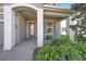 Cozy front porch with seating, welcoming entryway with decorative accents and lush landscaping at 4607 Ballantrae Boulevard, Land O Lakes, FL 34638