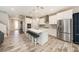 Modern kitchen featuring a large island with seating and stainless steel appliances at 4607 Ballantrae Boulevard, Land O Lakes, FL 34638