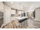 Modern kitchen featuring white cabinets, stainless steel appliances, kitchen island with seating, and pendant lighting at 4607 Ballantrae Boulevard, Land O Lakes, FL 34638