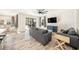 Cozy living room featuring stylish wood-look tile floors, modern furnishings, and abundant natural light at 4607 Ballantrae Boulevard, Land O Lakes, FL 34638