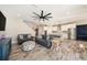 Open-concept living area with wood-look tile floors, seamlessly connecting to the modern kitchen at 4607 Ballantrae Boulevard, Land O Lakes, FL 34638
