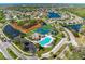 Aerial view of the community with pools, tennis courts, playgrounds, and waterways at 4712 Trout River Xing, Ellenton, FL 34222