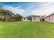 Well-maintained backyard with green lawn and view of a lake in the distance at 4712 Trout River Xing, Ellenton, FL 34222