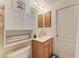 Bright bathroom with white cabinets, vanity sink, and decorative accents at 4712 Trout River Xing, Ellenton, FL 34222