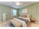 Cozy bedroom with green walls, decorative wall art, and natural light at 4712 Trout River Xing, Ellenton, FL 34222