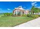Exterior of the clubhouse showcasing a well-manicured lawn and a side of tennis courts at 4712 Trout River Xing, Ellenton, FL 34222