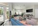 Bright clubhouse featuring ample seating, a large-screen TV, and plenty of natural light at 4712 Trout River Xing, Ellenton, FL 34222