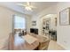 Bright dining room featuring a wooden table, beverage cooler, and coffee station at 4712 Trout River Xing, Ellenton, FL 34222