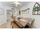Bright dining room with wood table, tufted seating, and decorative wall art at 4712 Trout River Xing, Ellenton, FL 34222