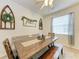 Bright dining room featuring a wooden table, bench seating, and stylish decorations at 4712 Trout River Xing, Ellenton, FL 34222