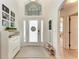 Bright foyer with high ceilings, decorative front door with sidelights, transom window and stylish furnishings at 4712 Trout River Xing, Ellenton, FL 34222