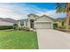 Charming single-story home featuring a two-car garage, manicured lawn, and a welcoming, landscaped front yard at 4712 Trout River Xing, Ellenton, FL 34222