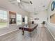 Fun game room with pool table, plenty of windows for natural light, and ceiling fans for climate control at 4712 Trout River Xing, Ellenton, FL 34222