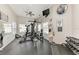 Weight-training gym featuring ceiling fans, mirrors, a mounted TV, and ample lighting at 4712 Trout River Xing, Ellenton, FL 34222