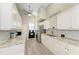 Well-lit kitchen with white cabinetry, granite countertops, and modern appliances at 4712 Trout River Xing, Ellenton, FL 34222