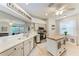 Beautiful kitchen featuring stone countertops, stainless appliances, white cabinetry, island, and access to the living room at 4712 Trout River Xing, Ellenton, FL 34222