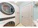 Convenient laundry room with white cabinets and modern washer and dryer at 4712 Trout River Xing, Ellenton, FL 34222