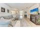 Spacious living room featuring an electric fireplace and a view towards the foyer, kitchen, and dining area at 4712 Trout River Xing, Ellenton, FL 34222