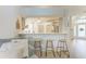 Open living room area featuring counter seating and bright kitchen beyond at 4712 Trout River Xing, Ellenton, FL 34222