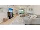 Comfortable living room featuring a cozy fireplace, neutral-toned furniture, and access to outdoor space at 4712 Trout River Xing, Ellenton, FL 34222