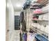 Organized walk-in closet with shelving and storage for clothing and accessories at 4712 Trout River Xing, Ellenton, FL 34222