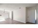 Inviting living room with wood-look floors leading to the front door and onward to additional rooms at 4726 Grove Point Dr, Tampa, FL 33624