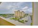 High-rise condo building with beautiful water views on a sunny day with lush landscaping at 4750 Cove Cir # 706, St Petersburg, FL 33708