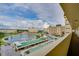 Condo building featuring beautiful water views, tropical landscaping, and a parking garage at 4750 Cove Cir # 706, St Petersburg, FL 33708