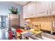 Practical kitchen with a stainless fridge, white cabinets, and neutral backsplash at 4750 Cove Cir # 706, St Petersburg, FL 33708