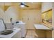 Laundry room featuring a washer, dryer, storage lockers, and a folding table at 4750 Cove Cir # 706, St Petersburg, FL 33708