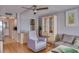 Relaxing living area with neutral walls and seating and a view to kitchen at 4750 Cove Cir # 706, St Petersburg, FL 33708