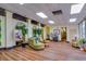 Bright lobby featuring wood floors, plants, comfortable seating areas, and well maintained floors at 4750 Cove Cir # 706, St Petersburg, FL 33708