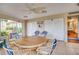 Seating area featuring rattan chairs with round wood table and tiled floors at 4750 Cove Cir # 706, St Petersburg, FL 33708