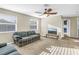 Bright living room with natural light, ceiling fan, and striped sofa at 4804 Patagonia Pl, Land O Lakes, FL 34638