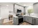 Modern kitchen with gray cabinetry, stainless steel appliances, and subway tile backsplash at 5107 S Renellie Dr, Tampa, FL 33611