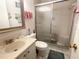 Bathroom with tiled shower and a glass door at 5660 80Th N St # A304, St Petersburg, FL 33709