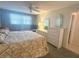 This bedroom features a large window, ceiling fan, and dresser with mirrors at 5660 80Th N St # A304, St Petersburg, FL 33709