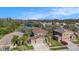 Aerial view showcasing the home's location within a serene, tree-lined community near a lake at 5843 Justicia Loop, Land O Lakes, FL 34639