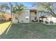 Spacious backyard with lush lawn, patio seating, and a gazebo, perfect for outdoor entertaining at 5843 Justicia Loop, Land O Lakes, FL 34639