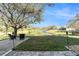 Scenic backyard with a brick patio, comfortable seating, and views of a serene pond and lush landscaping at 5843 Justicia Loop, Land O Lakes, FL 34639