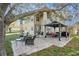 Spacious backyard featuring outdoor seating and a covered gazebo with a stone patio at 5843 Justicia Loop, Land O Lakes, FL 34639