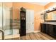 Bathroom boasts a modern vanity with granite countertops, and a stand alone glass shower at 5843 Justicia Loop, Land O Lakes, FL 34639