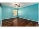 Spacious bedroom with hardwood flooring, lots of natural light, and a ceiling fan at 5843 Justicia Loop, Land O Lakes, FL 34639