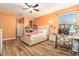 Bright bedroom with a large window, light wood floors, and comfortable furnishings at 5843 Justicia Loop, Land O Lakes, FL 34639